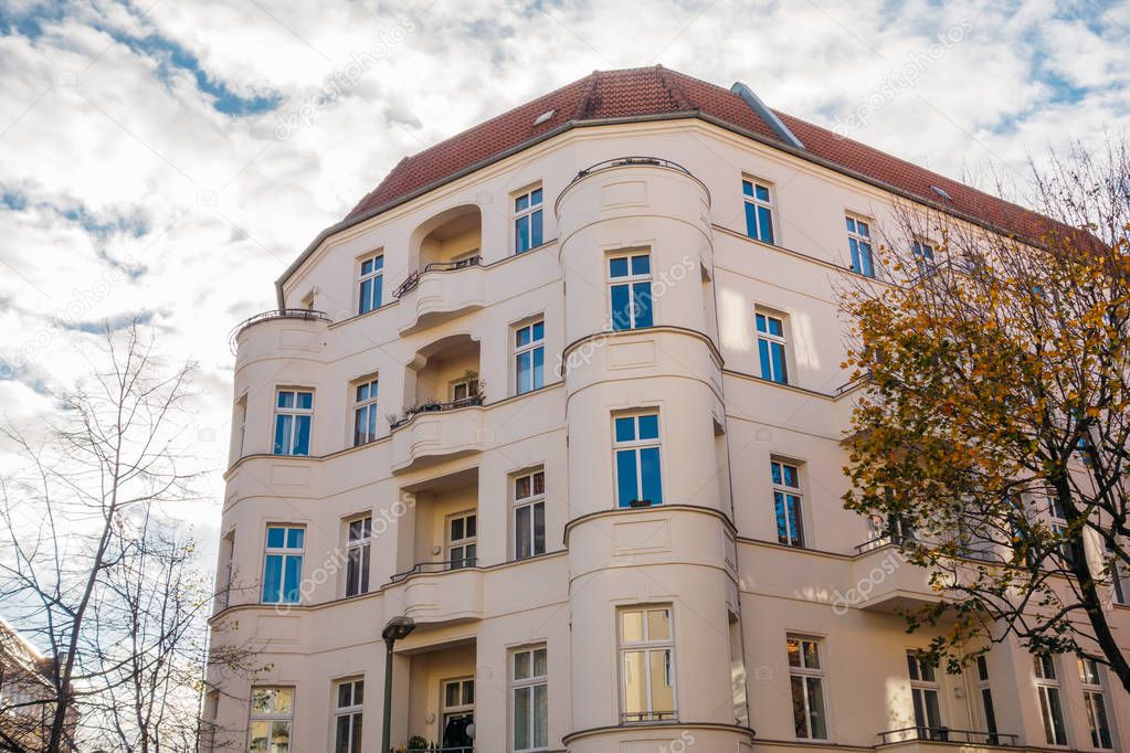 big corner building with fluffy clouds