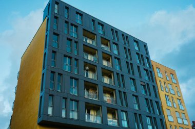 yellow and black facaded modern apartment complex