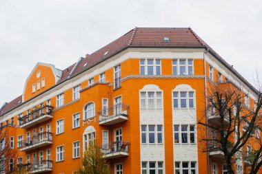 orange corner building with grey sky