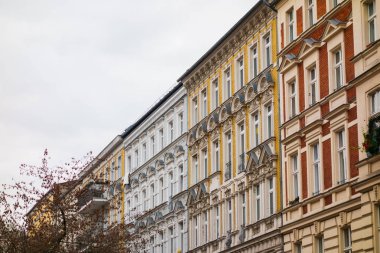 Side view of colorful tenement buildings facades