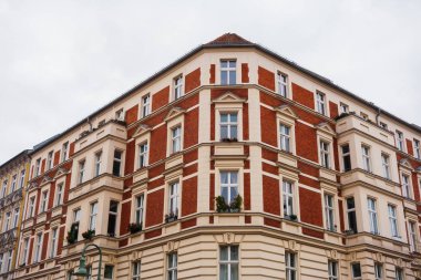 Red tenement building corner in low angle view