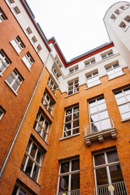 backyard of brick office building with white detailes in the facade