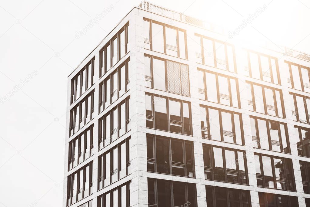 high contrasted modern office building with warm lens flare