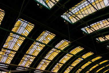 old train station roof with steel construction and colorful glass windows