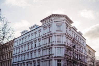 white residential corner building in warm colors