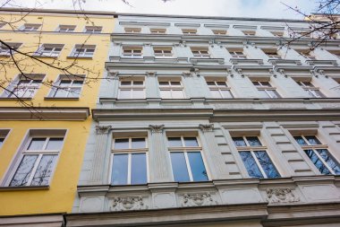 detailed view of white facaded building next to an white house