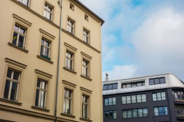orange and black facaded apartment buildings with copy space in the middle