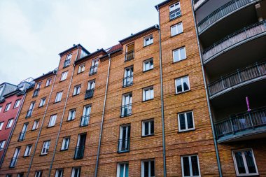 brick apartment building with curved balcony