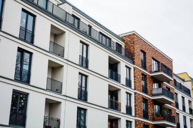 white modern apartment building with brick details in high contrasts