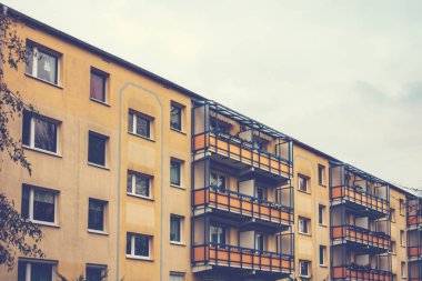 yellow apartment building on a cloudy day