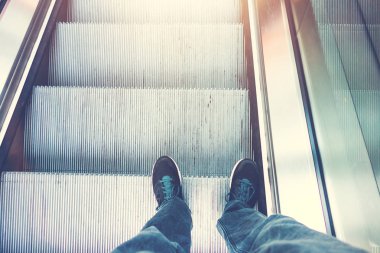 hdr picture of man standin on a escalator