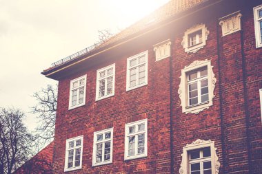 detailed view of brick apartment building in sunlight