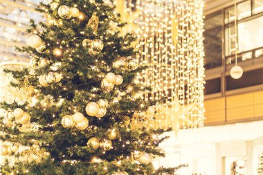 shining christmas tree with lights in the background