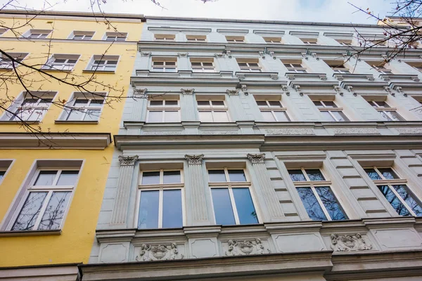 detailed view of white facaded building next to an white house