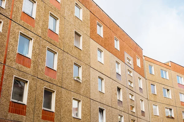 brown and red facaded gdr plattenbau building