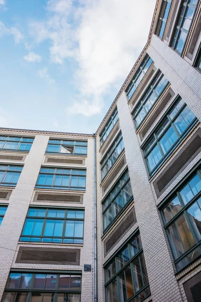 high formated picture of brick apartment house with square blue windows