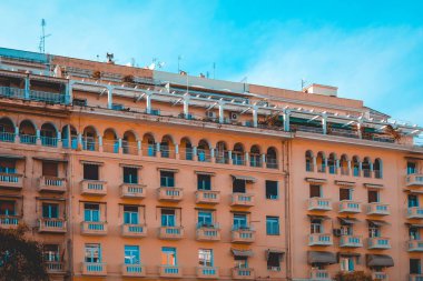 orange big apartment complex with white rooftop balcony