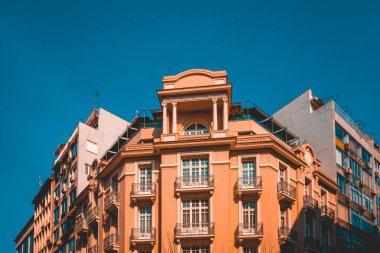 orange corner building with darken blue sky