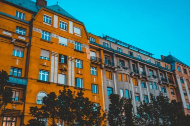 orange and brown facaded houses with darken blue sky