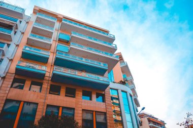 low angle view of orange and blue colored apartment or office building