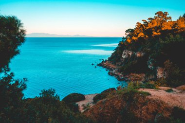 majestic cliffs at greece framed by trees