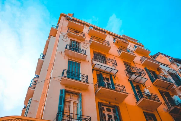 low angle view of orange apartment complex at thessaloniki