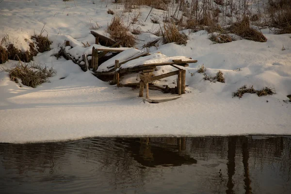 Klyazma evaporating river at dawn in winter