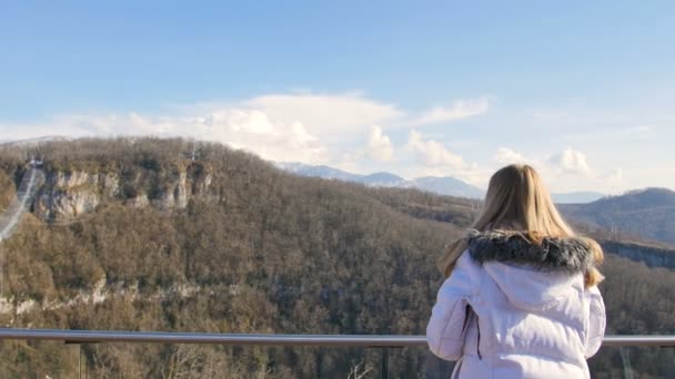 Pont d'observation skybridge. Femme enjoignant la lumière du soleil et vue sur les paysages des montagnes — Video