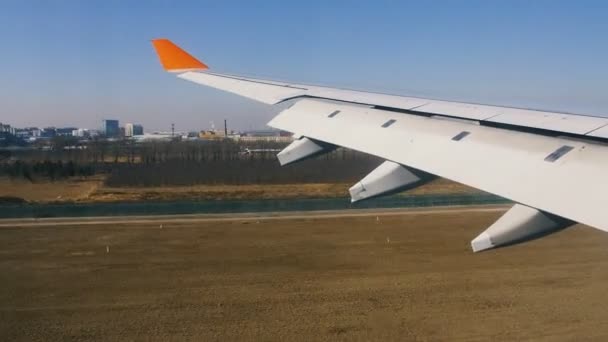 Airplane landing at airport, view of the wing from inside — Stock Video