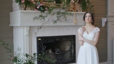 Güzel oynak esmer gelin poz şömine arka plan beyaz elbise