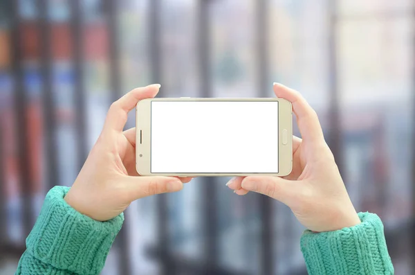 Smart phone horizontal position in woman hand. Isolated, white screen for mockup.