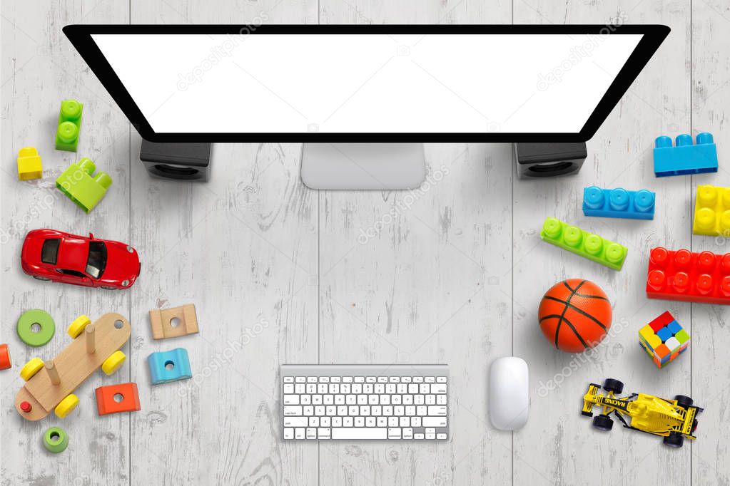 Children work desk with computer and toys. Creative scene with free space for text. Top view. Display mockup.