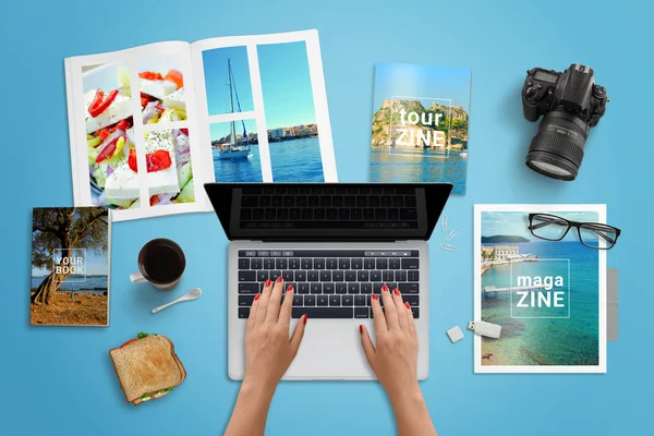 Travel agency work desk. Woman typing on laptop computer with blank screen for mockup