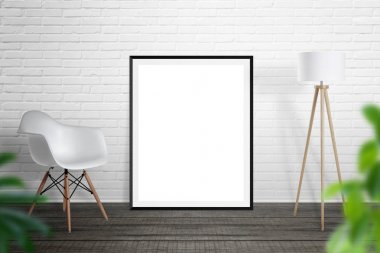 Boş resim çerçevesini tuğla duvara yaslandı. Sandalye ve lamba yanında