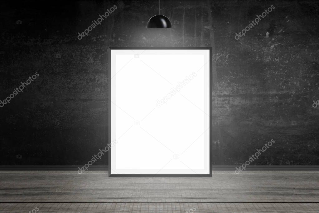 Picture frame illuminated with lamp. Empty space, blank, white paper for mockup. Black wall in background. Wooden floor