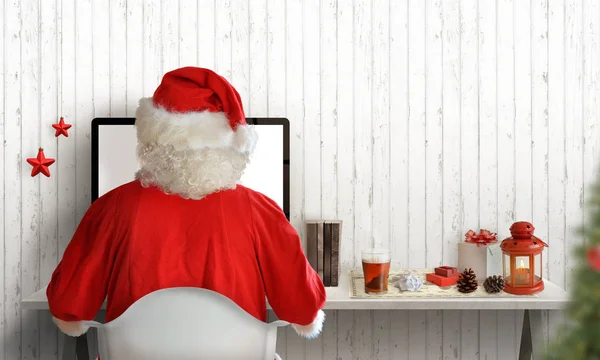 Santa Claus work on computer and send letters to kids. Christmas tree, gifts, and decorations beside. Free space for greeting text.