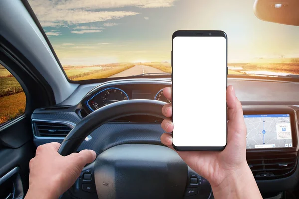 Driver keeps the phone while driving. Isolated screen for mockup. Modern car interior with navigation on board screen.