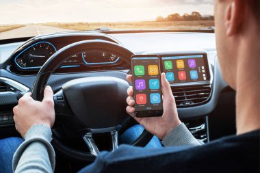 Araba sürücü kullanım akıllı telefon bağlantısıyla sürüş sırasında akıllı araç app ve kullanım araba bilgi-eğlence sistemi ile.