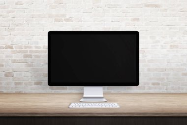 Temiz işyeri ile bilgisayar göstermek. Boş ekran web sitesi promosyon için. Boş masa ve tuğla duvar.