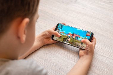 Sarajevo, Bosnia and Herzegovina - November 29, 2019: PlayerUnknown's Battlegrounds or PUBG game on modern smart phone in boy hands clipart