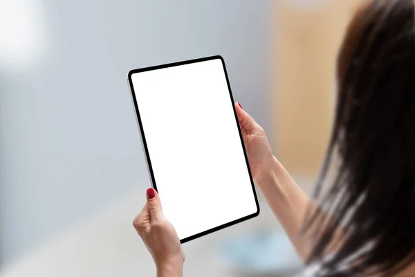 Woman holding tablet in vertical position with isolated screen for app or web site presentation. Modern tablet with thin, round edges