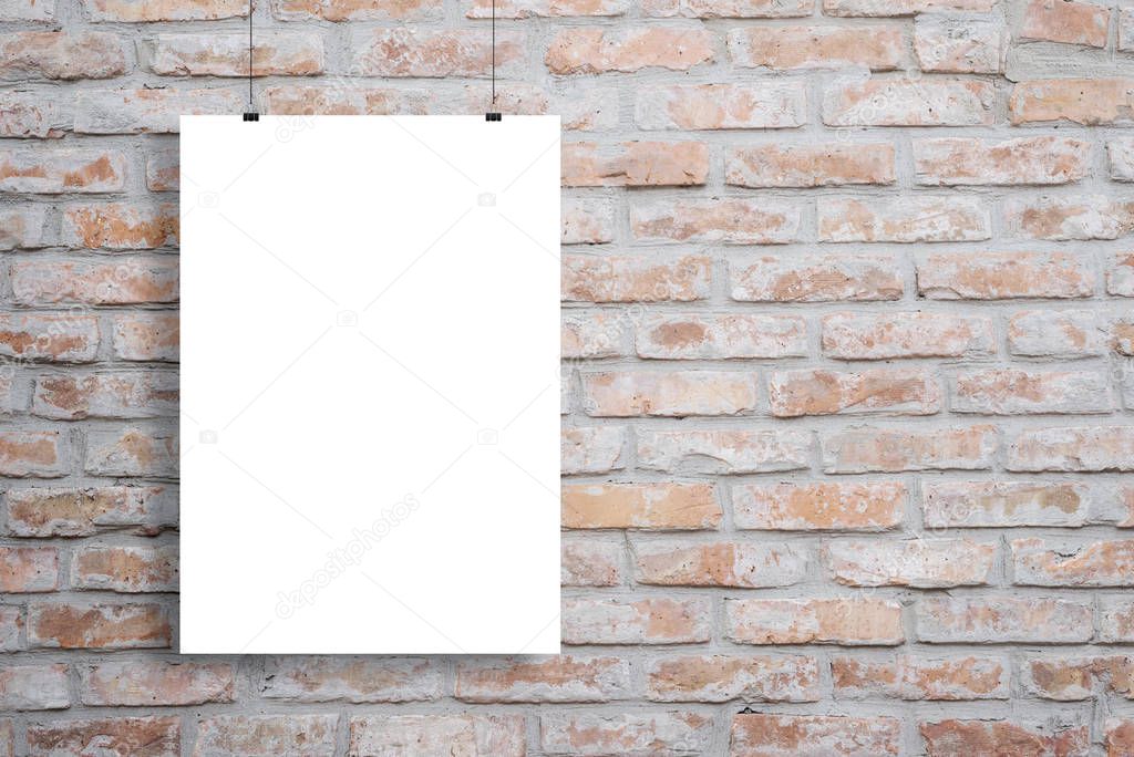 Blank poster mockup hanging across brick wall with copy space beside