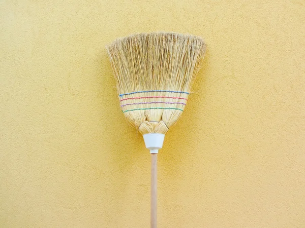 Isolated country broom on yellow background — Stock Photo, Image