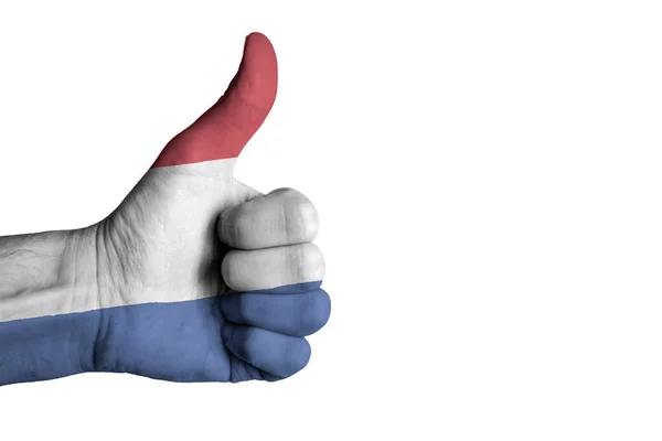 Nederlandse vlag op menselijke mannelijke duim hand — Stockfoto