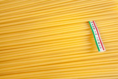 Made in Italy label over uncooked Italian spaghetti clipart