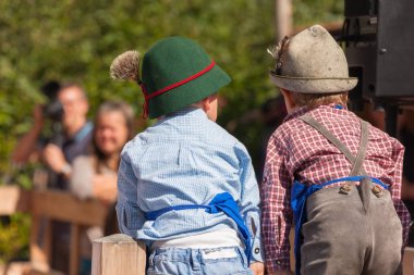 Young children in typical costume during an autumn local celebration in Val di Funes ( South Tyrol ) clipart