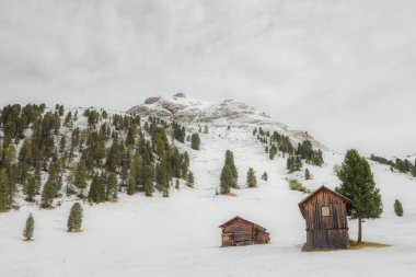 Val di Funes 'da sonbahar kar yağışı sonrası bir otlakta eski bir saman.