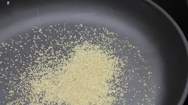 Amaranth being popped in cast-iron pan — Stock Video