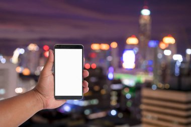 elini tut mobil Cityscape bokeh, bulanık fotoğraf, cityscape üzerinde twilight saat