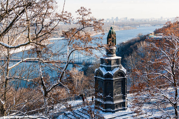 Bronze statue of St. Vladimir in Kiev. Daytime view of the snow.
